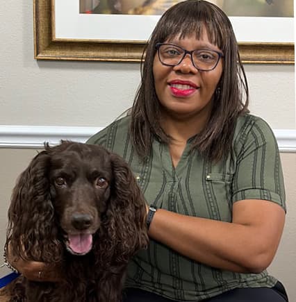 Ihuoma J. with an Angel Paws therapy dog at Brookdale Champions